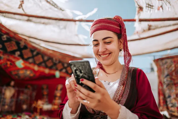 A woman smiling by bright slot machines showing lucky symbols, showcasing the exciting slot offerings at DEAWUN.
